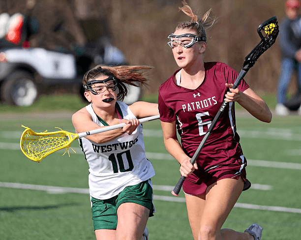 Two youth lacrosse players competing for the ball